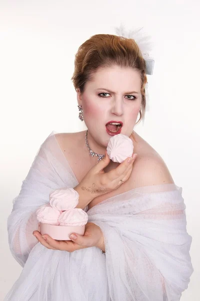 Plus size woman eats sweets with a pleasur — Stock Photo, Image